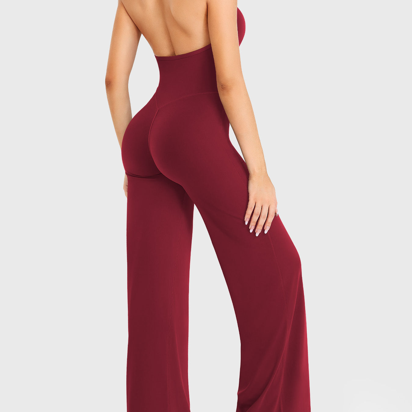 Side-front stretch pose wearing anchor red halter straight-leg jumpsuit