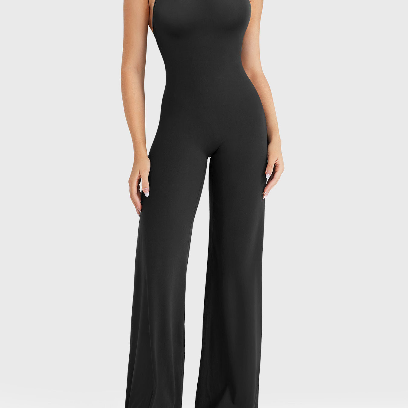 Front view—model wearing black halter open-back straight-leg jumpsuit