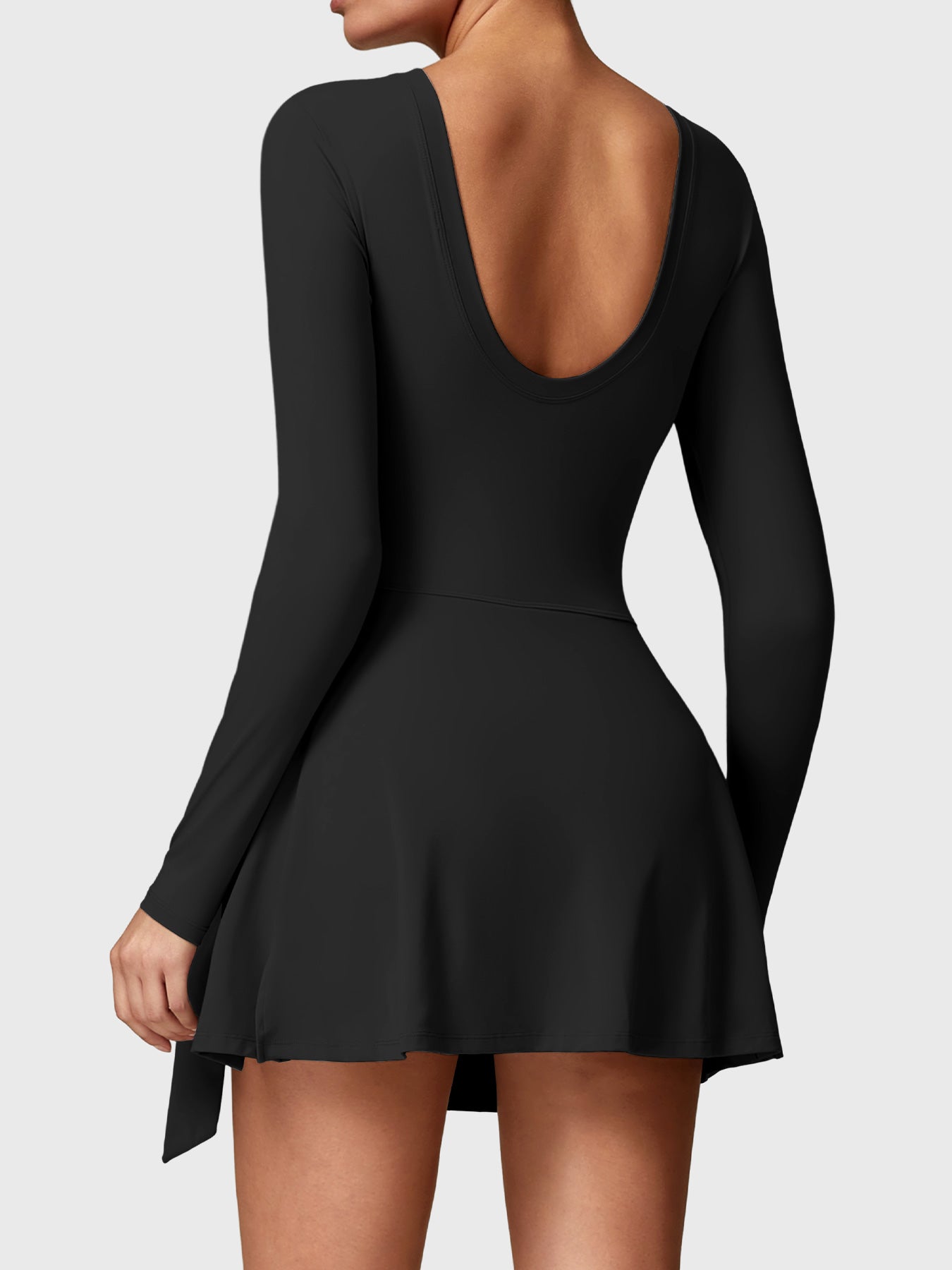 Back view of Yeoreo Renee Long Sleeve Tennis Dress in Black, highlighting U-back design