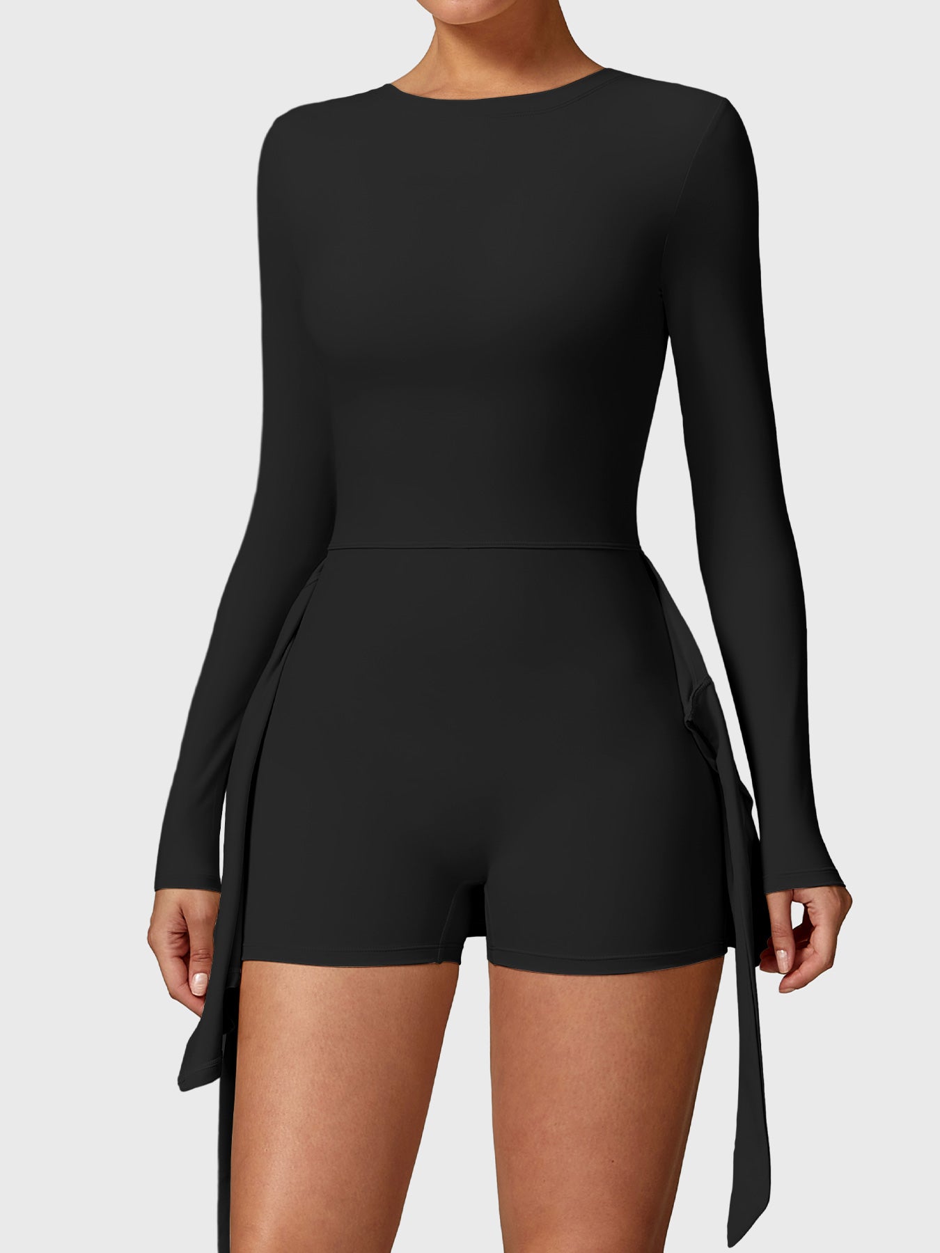 Front view of Yeoreo Renee Long Sleeve Tennis Dress in Black, showcasing built-in shorts