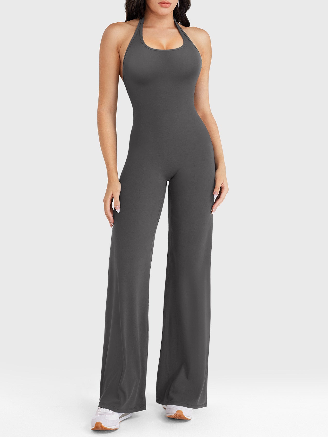 Front view—model wearing dark grey halter open-back straight-leg jumpsuit