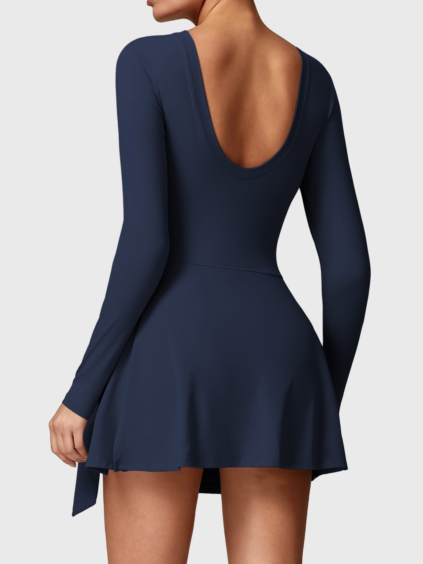 Back view of Yeoreo Renee Long Sleeve Tennis Dress in deep blue, highlighting U-back design