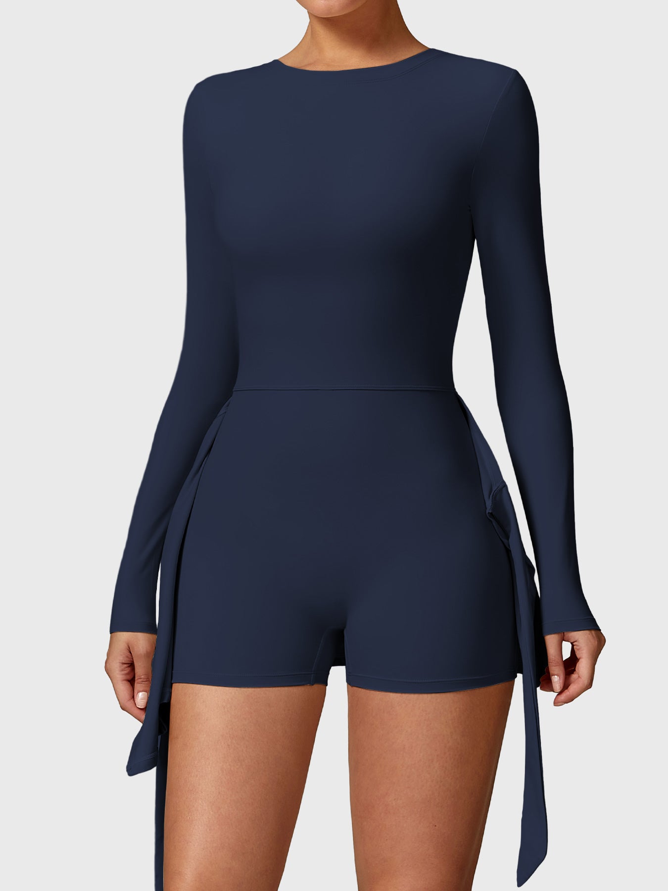 Front view of Yeoreo Renee Long Sleeve Tennis Dress in deep blue, showcasing built-in shorts