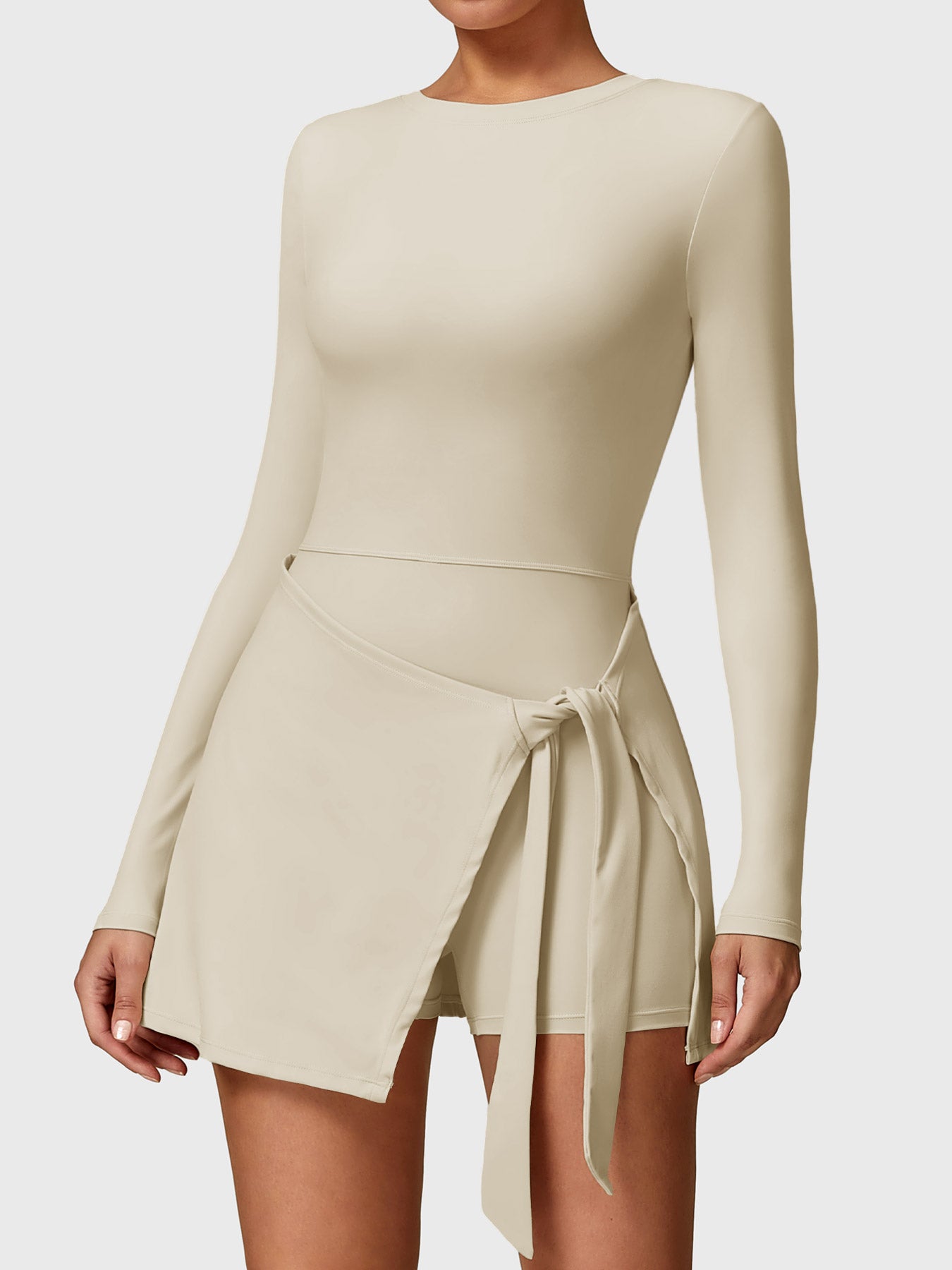 Front view of Yeoreo Renee Long Sleeve Tennis Dress in Light Khaki, showcasing round neckline and A-line skirt