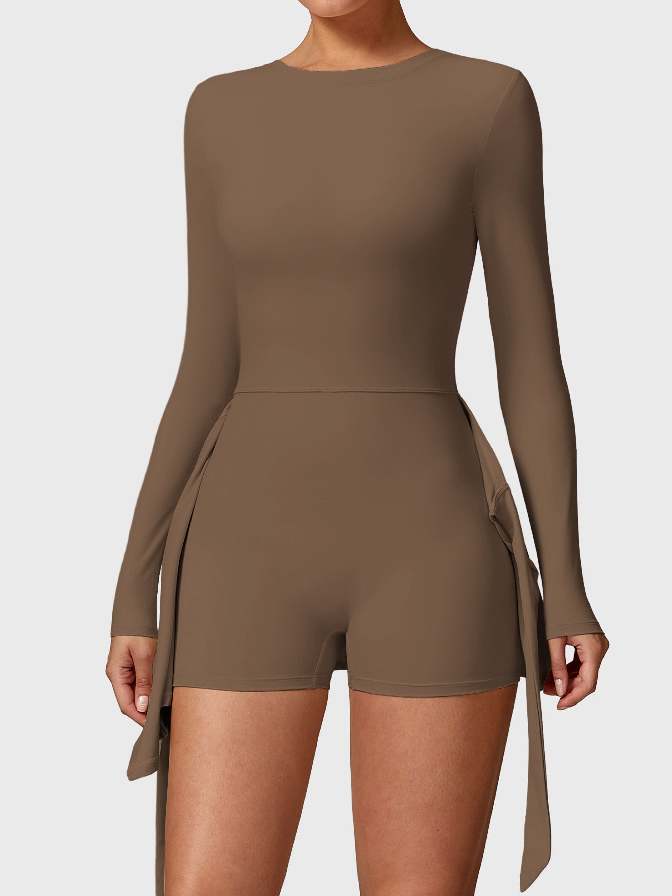 Front view of Yeoreo Renee Long Sleeve Tennis Dress in brown, showcasing built-in shorts