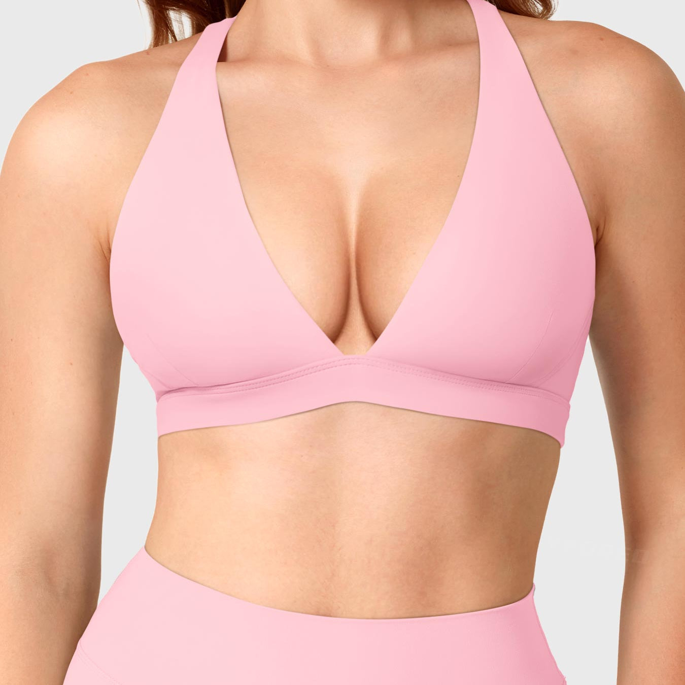 Baby Pink Yeoreo Wafiya cross back sports bra front view, plunge V-neck design with elastic underband support