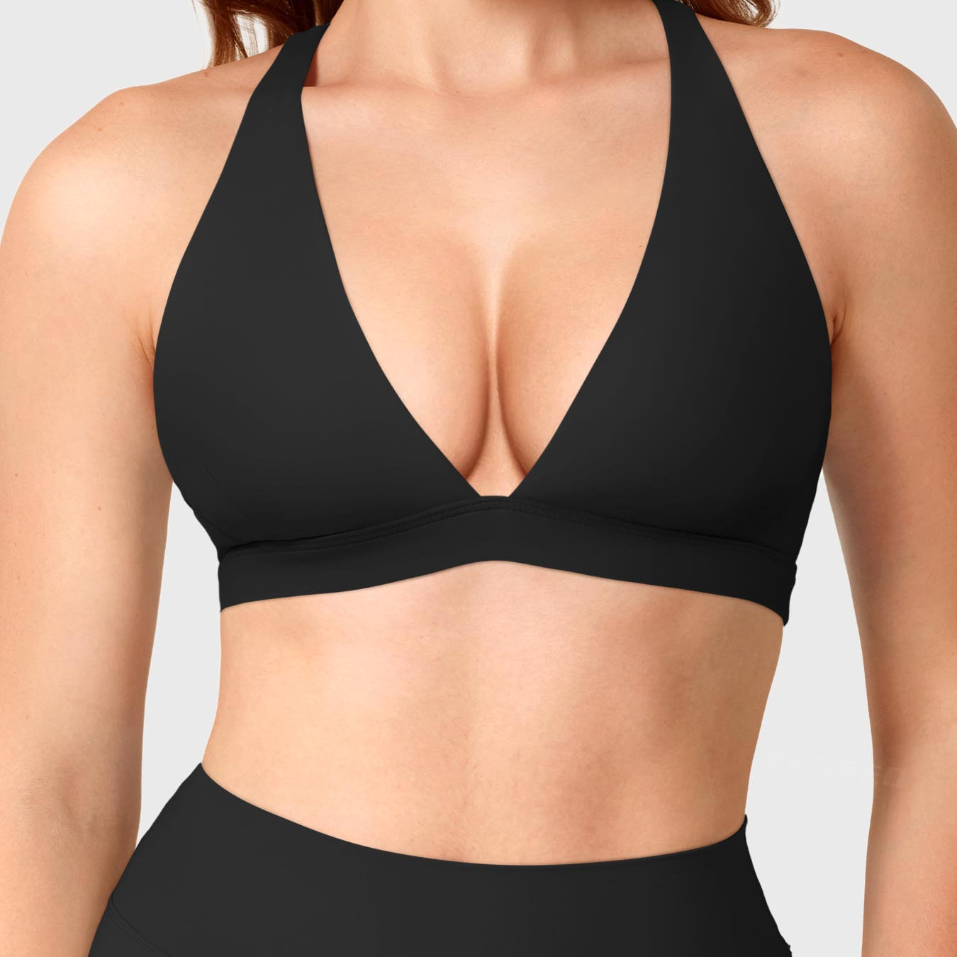 Black Yeoreo Wafiya cross back sports bra front view, plunge V-neck with supportive elasticated underband