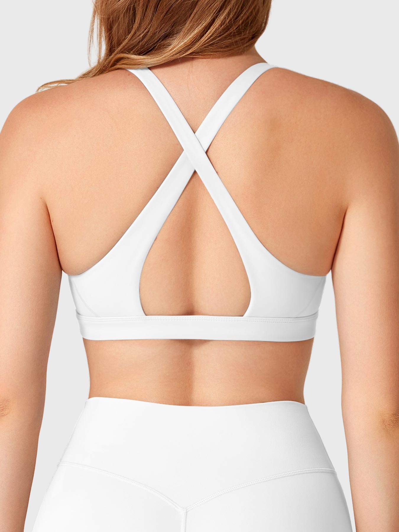 White Yeoreo Wafiya sports bra back view, crisscross open back detail highlighting natural back curve