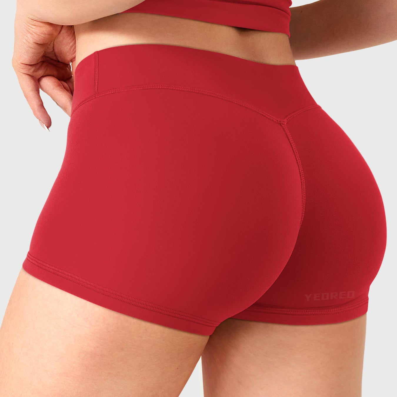 Red Yeoreo Zahida 2.5 inch low rise shorts angled back view, V-back contour enhancing glute shape