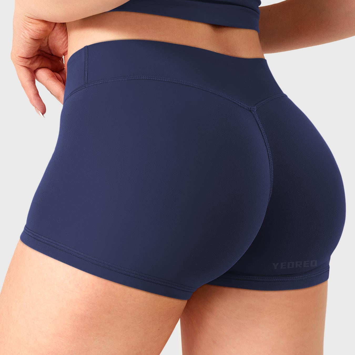 Dark Blue Yeoreo Zahida 2.5 inch low rise shorts angled back view, V-back waistband shaping curves
