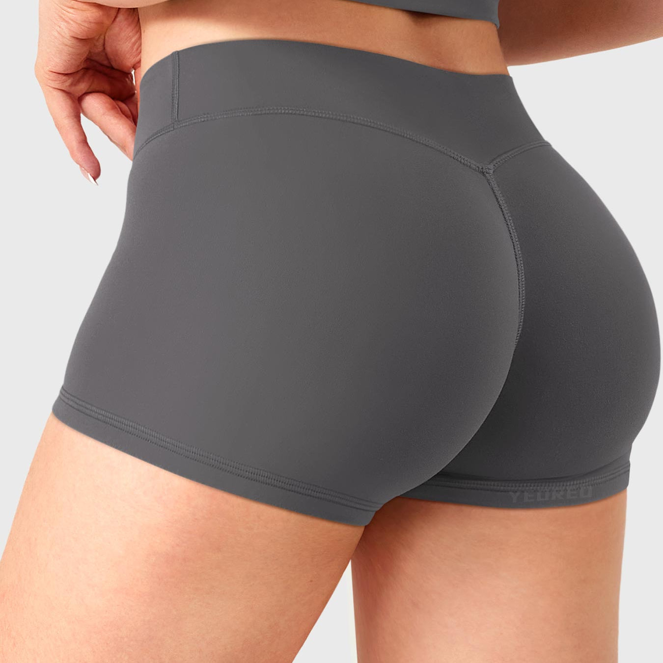 Dark Grey Yeoreo Zahida 2.5 inch low rise shorts angled back view, subtle V-back contour enhancing glutes