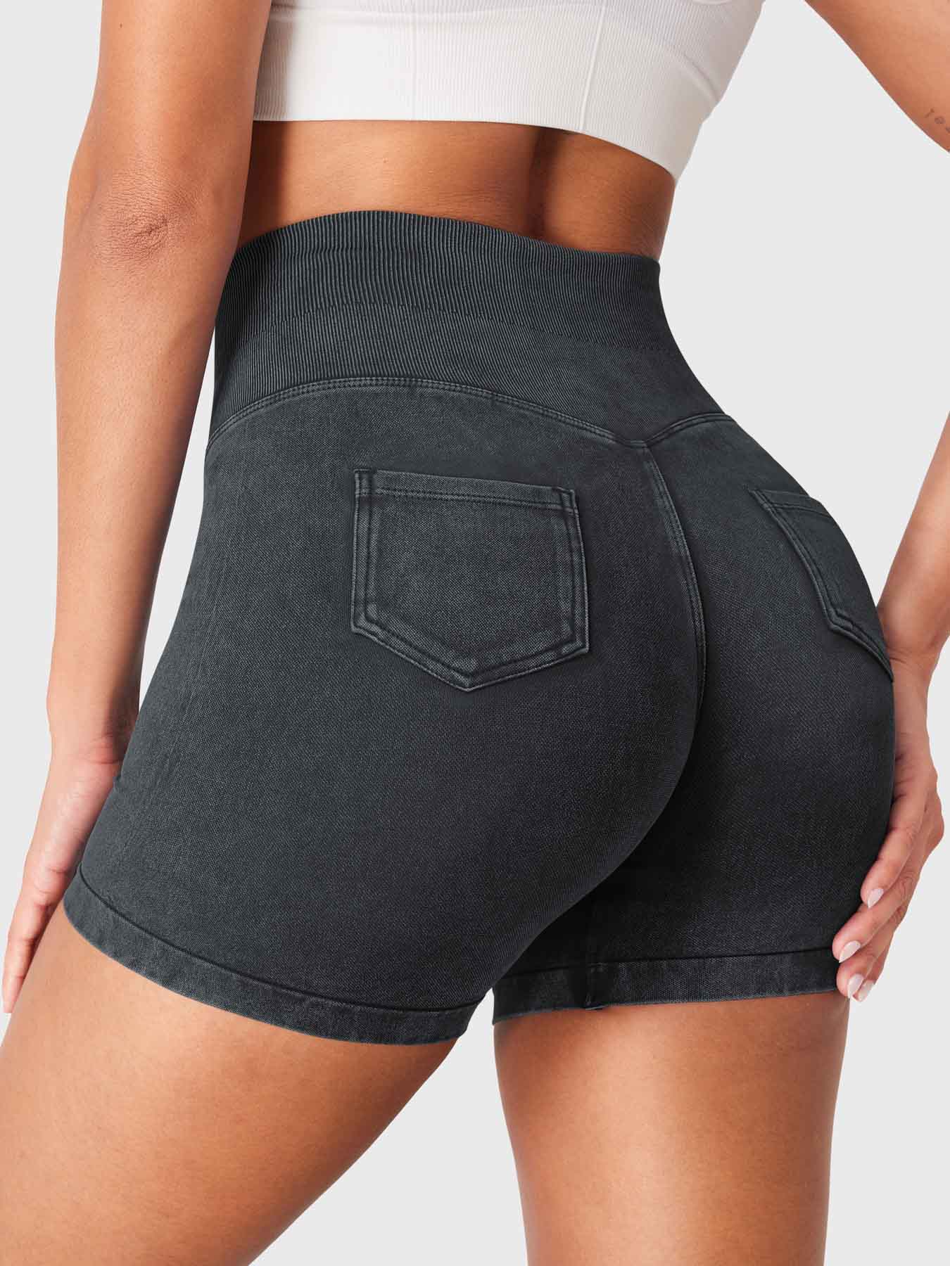 Side back view of Yeoreo Bridgie Faux Denim Seamless Shorts in black– mid-rise waistband and cargo pockets