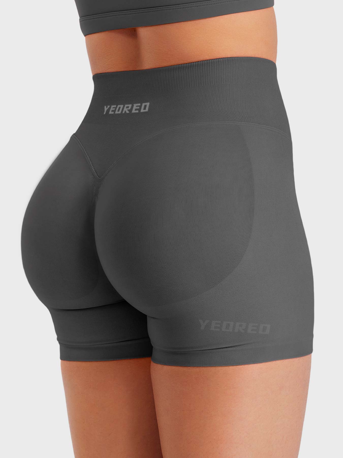 Dark Grey Baderiy 4.5" seamless shorts angled rear view, seamless structure enhancing body curves