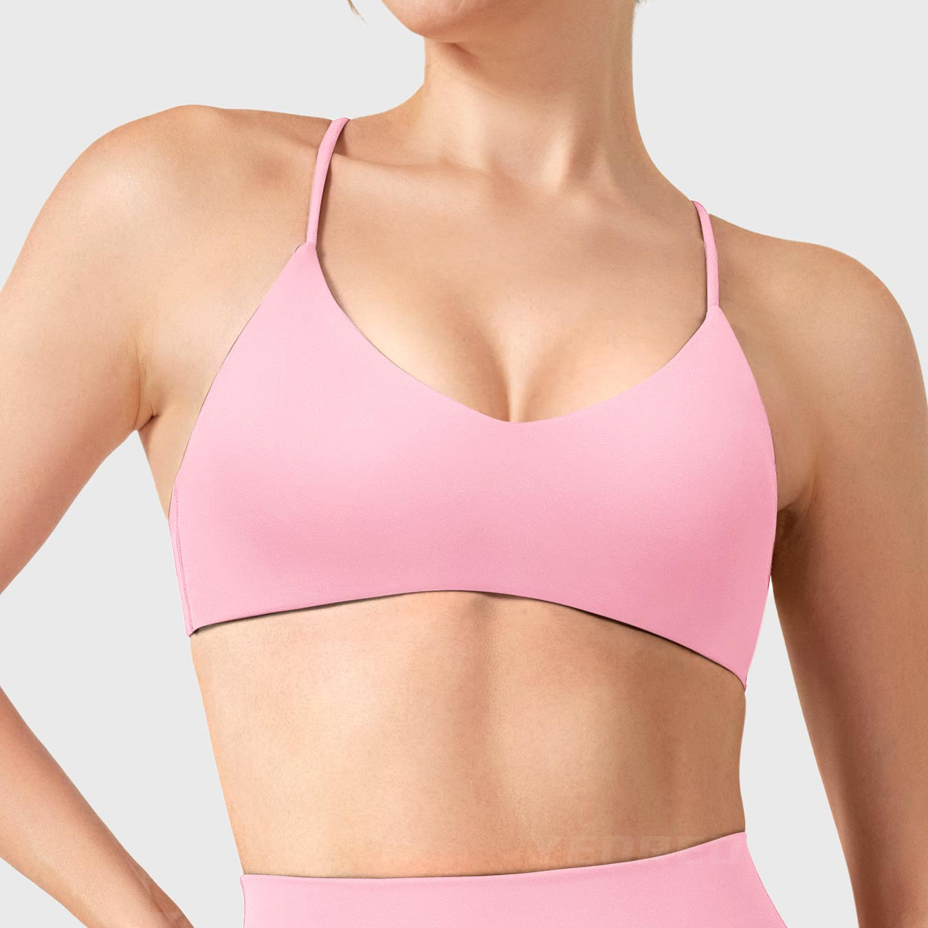 Baby Pink Yeoreo Zaahira V-neck sports bra front view, flattering neckline shaping collarbone and elongating neck