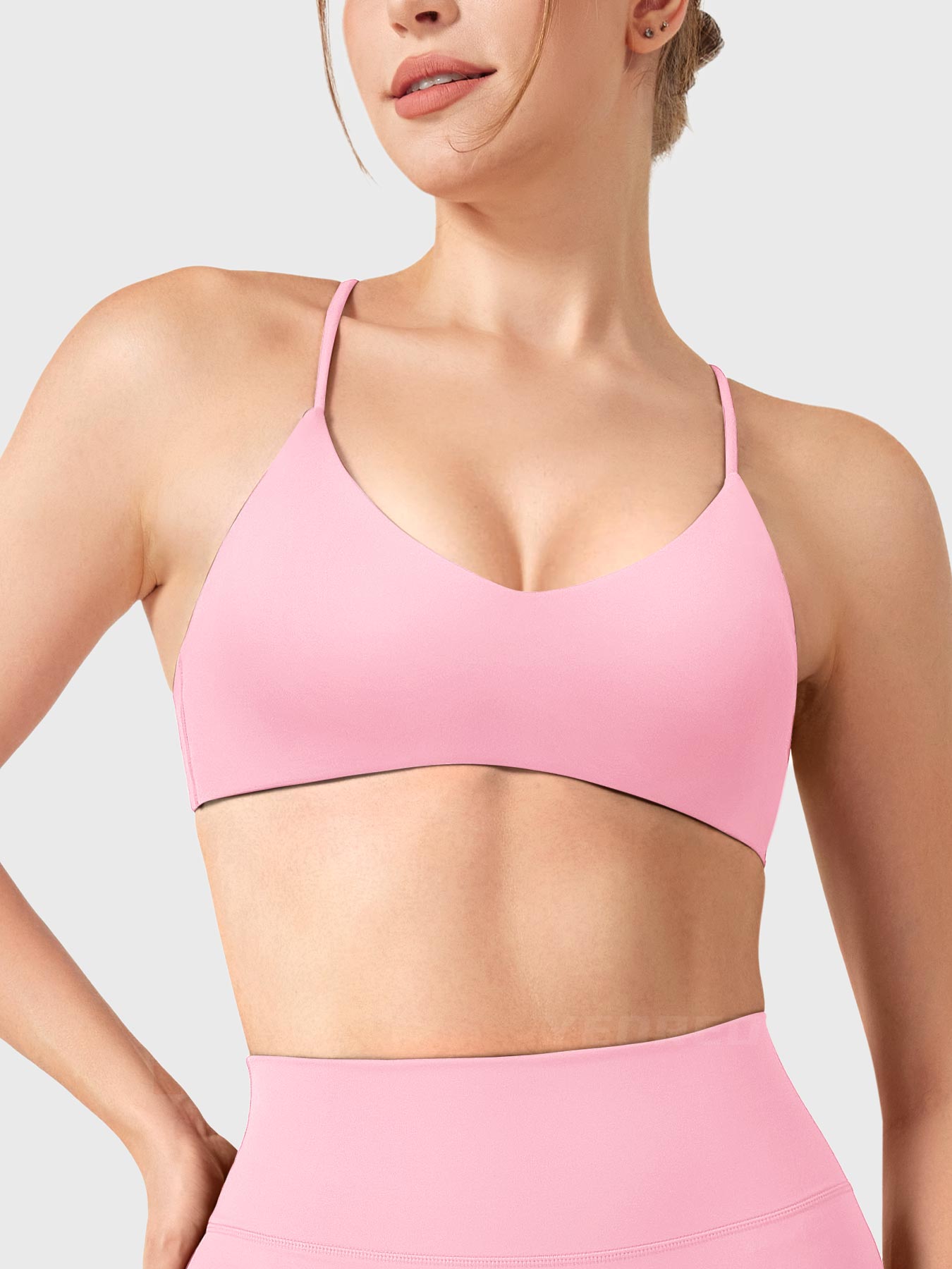 Baby Pink Yeoreo Zaahira V-neck sports bra front view, flattering neckline shaping collarbone and elongating neck