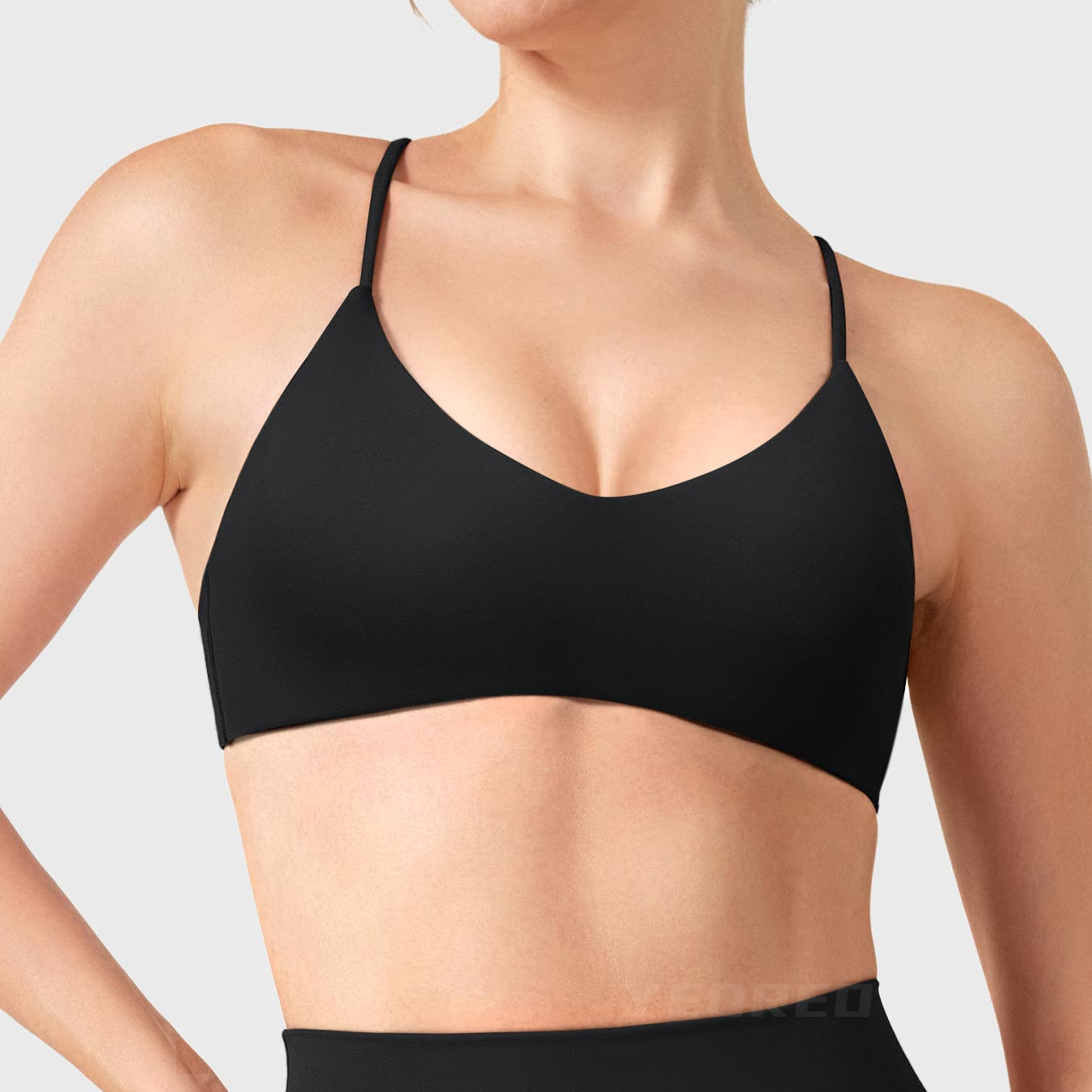 Black Yeoreo Zaahira V-neck sports bra front view, elegant neckline enhancing collarbone and shoulder line