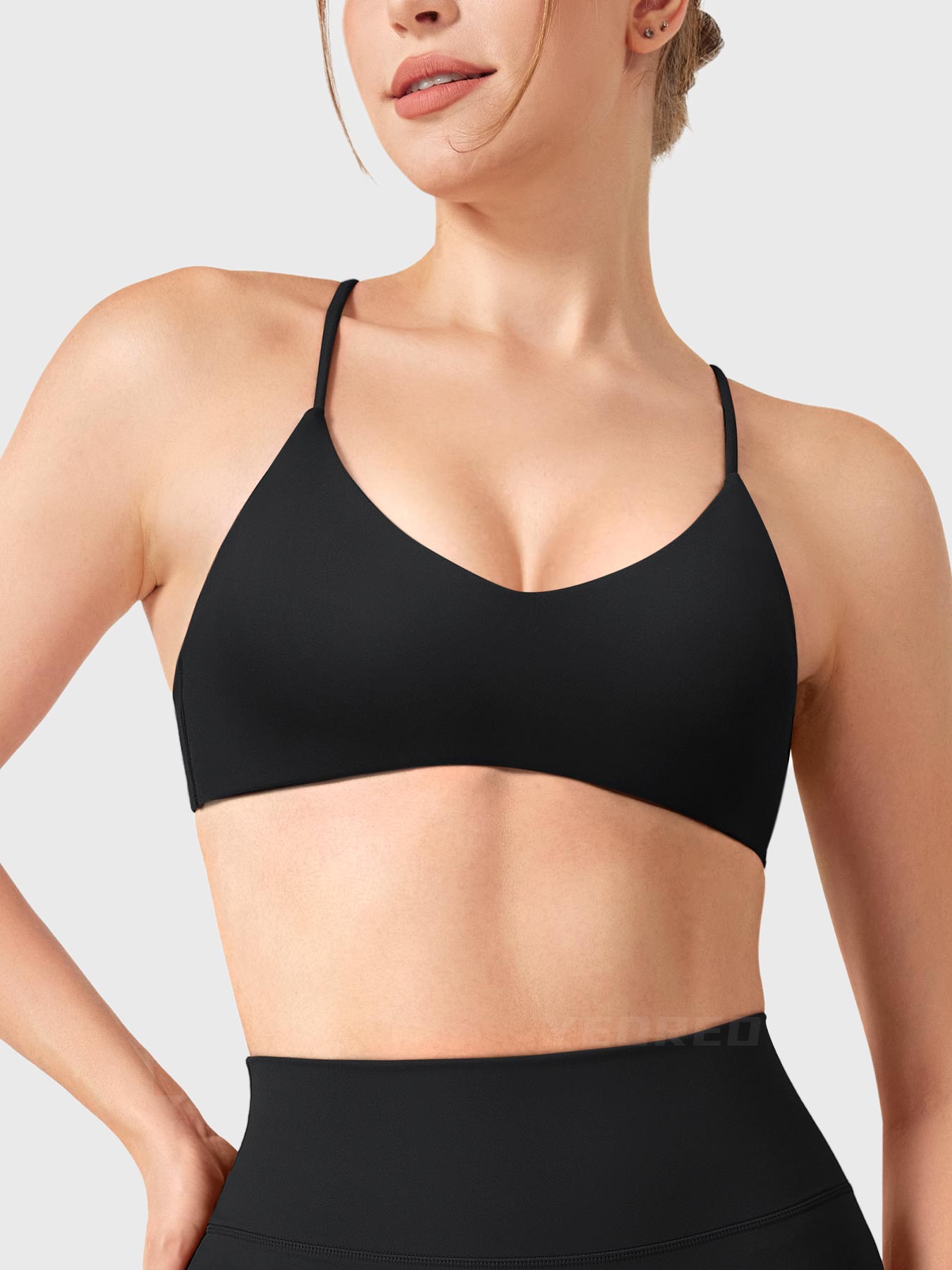 Black Yeoreo Zaahira V-neck sports bra front view, elegant neckline enhancing collarbone and shoulder line