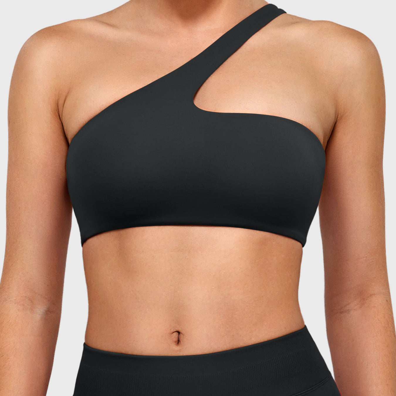 Claranie One Shoulder Sports Bra in black, front view upper body, asymmetric one shoulder design, sleek and sculpting fit