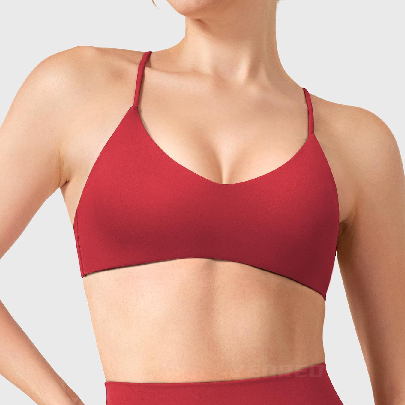 Maroon Yeoreo Zaahira V-neck sports bra front view, contouring neckline creating elongated upper body silhouette