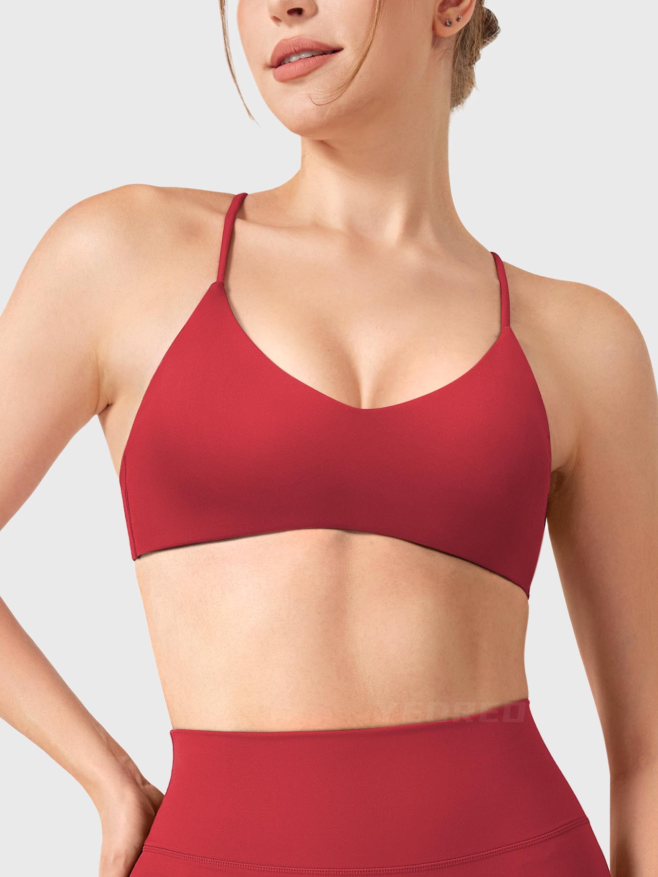 Maroon Yeoreo Zaahira V-neck sports bra front view, contouring neckline creating elongated upper body silhouette