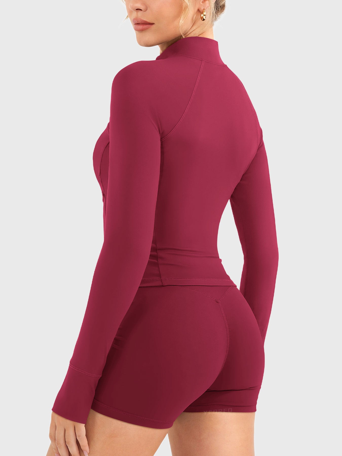 Candecy Full Zip Workout Jacket in ruby red, angled back view, clean back silhouette, slim and flattering cut