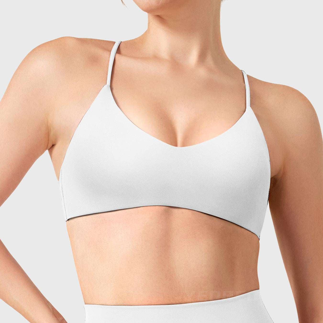 White Yeoreo Zaahira V-neck sports bra front view, elegant neckline enhancing posture and upper body lines