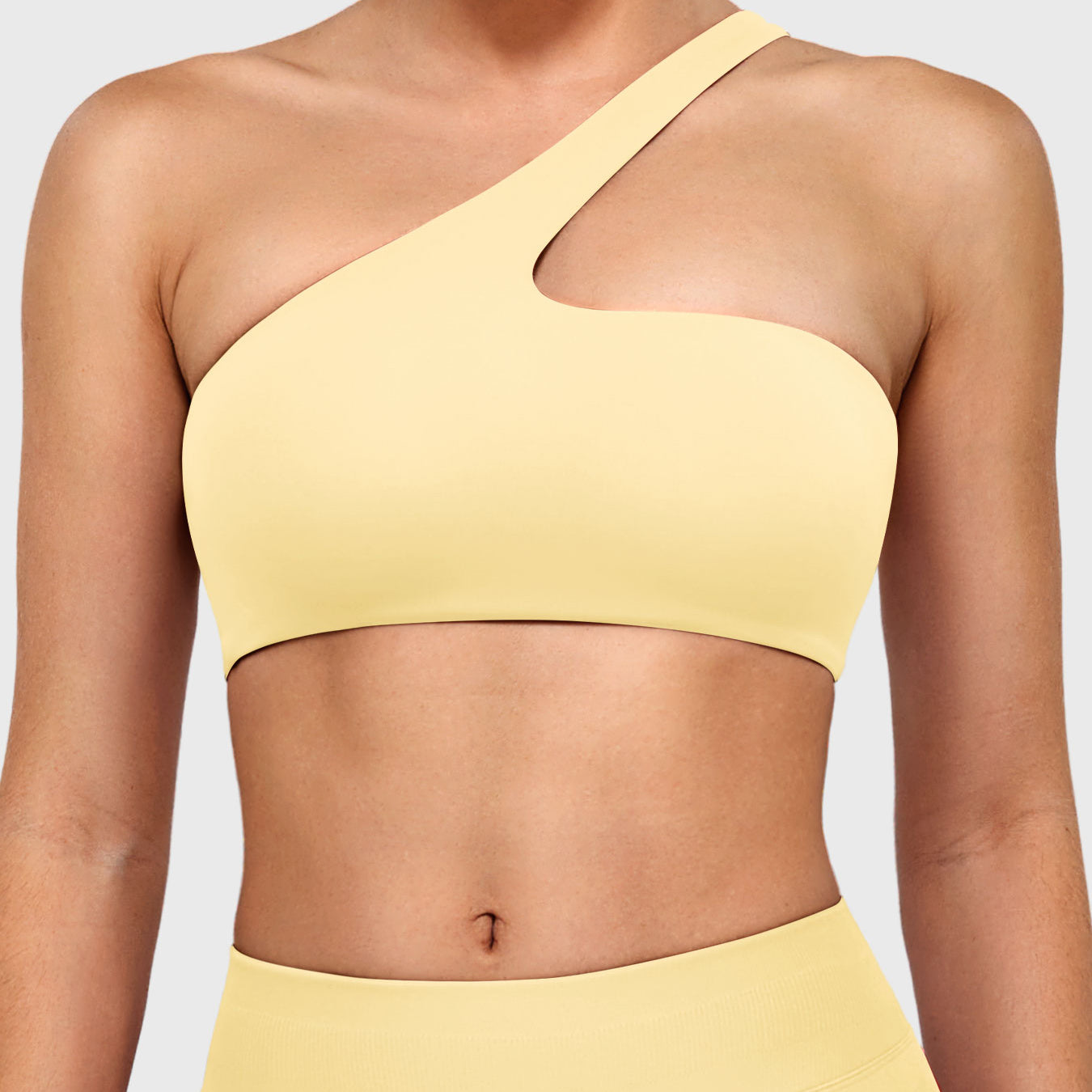 Claranie One Shoulder Sports Bra in milk yellow, front view upper body, asymmetric one shoulder neckline, smooth fitted silhouette