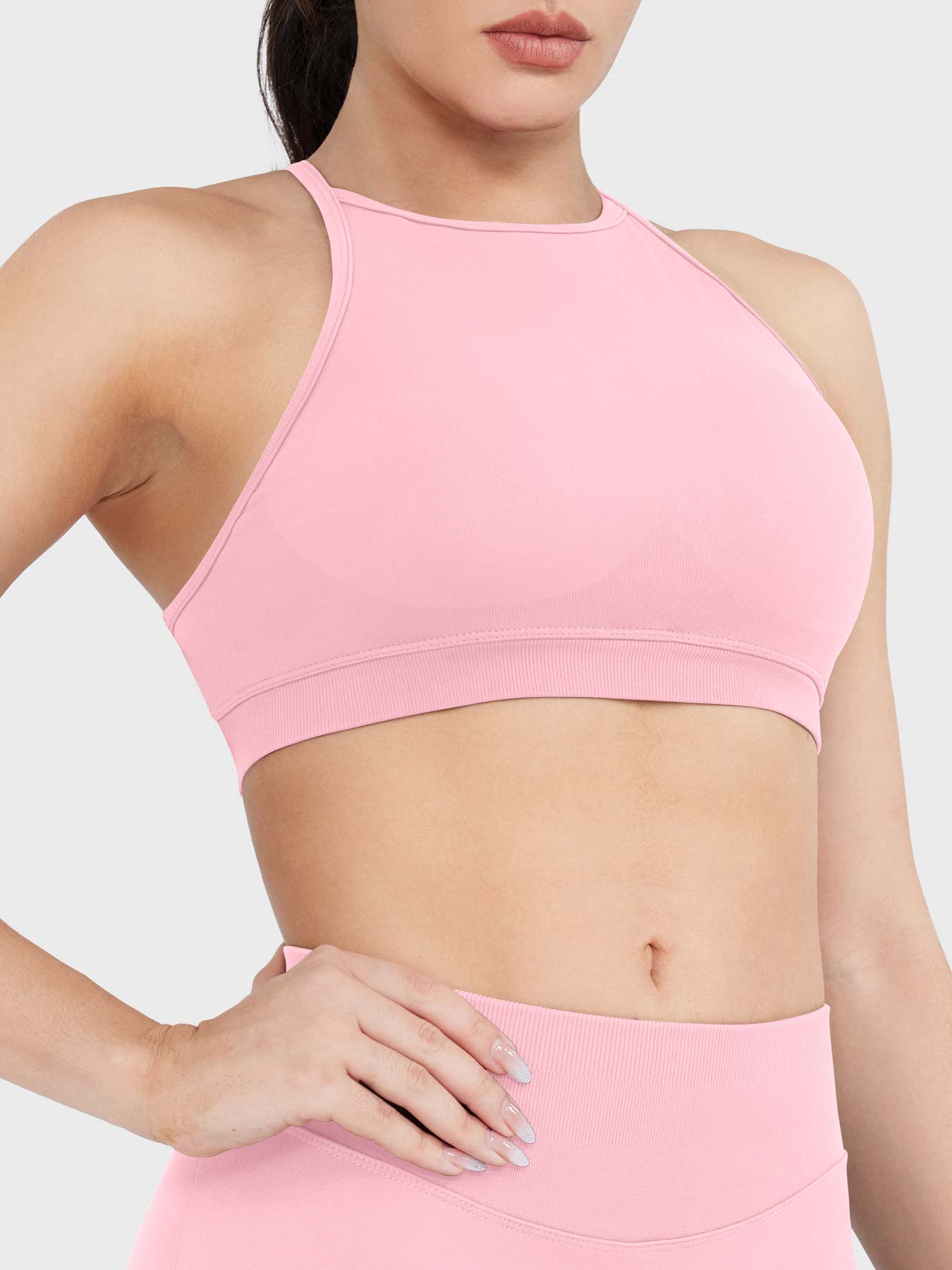 Acuffny High Neck Backless Sports Bra in pink, angled front upper body view, flattering bust contour, smooth supportive silhouette