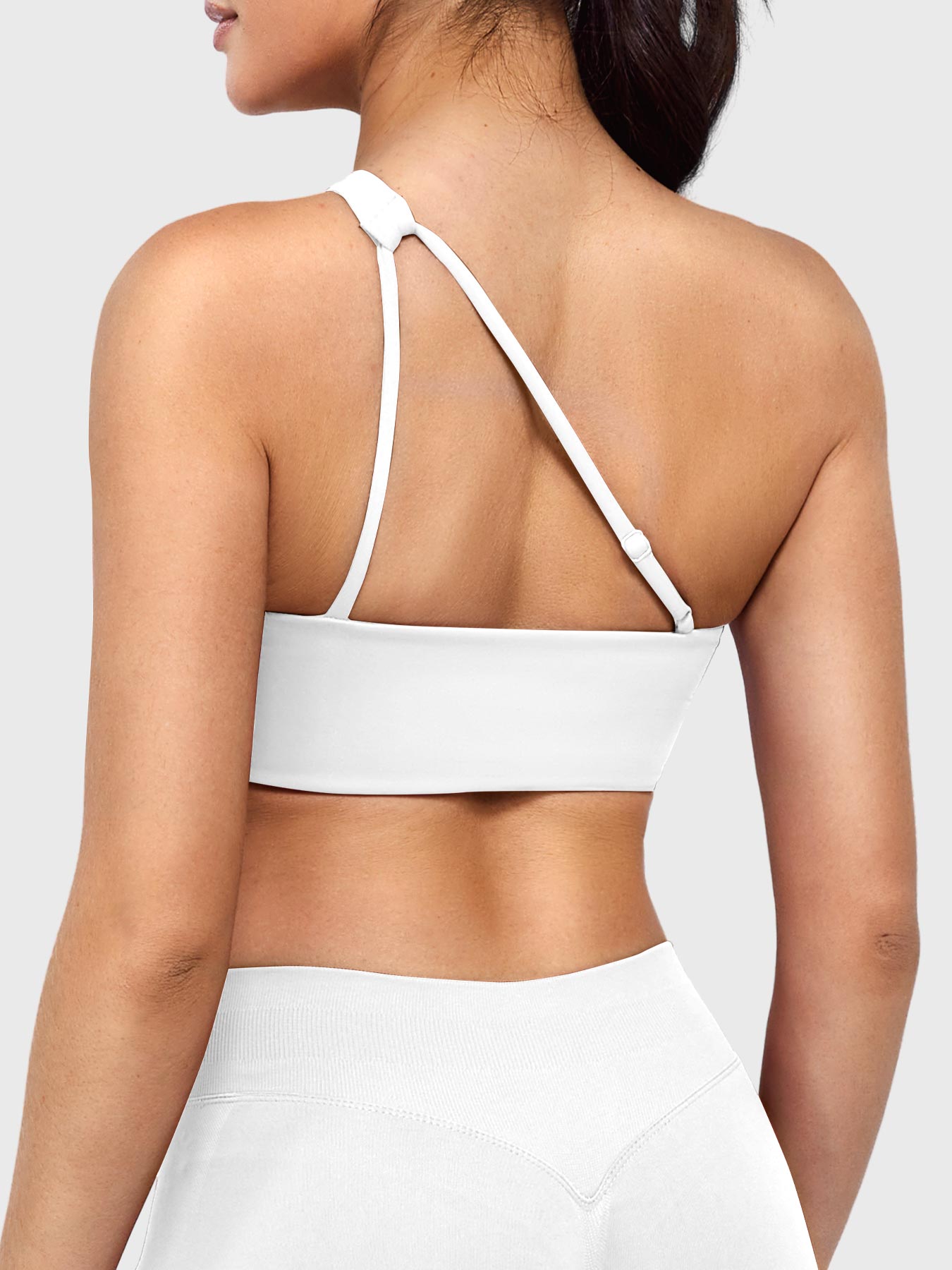 Claranie One Shoulder Sports Bra in white, angled back view upper body, open back design with adjustable strap, breathable and elegant