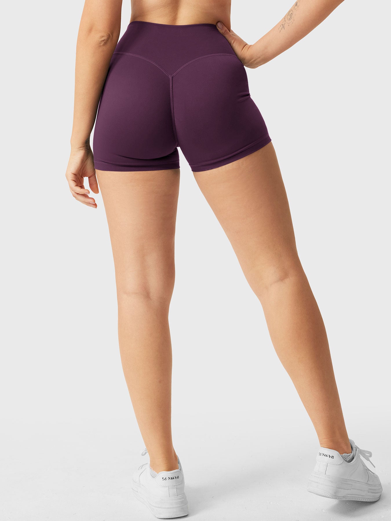 Full-length back view of Yeoreo Elysina 2.5" Running Shorts in Black Cherry from waist to shoes