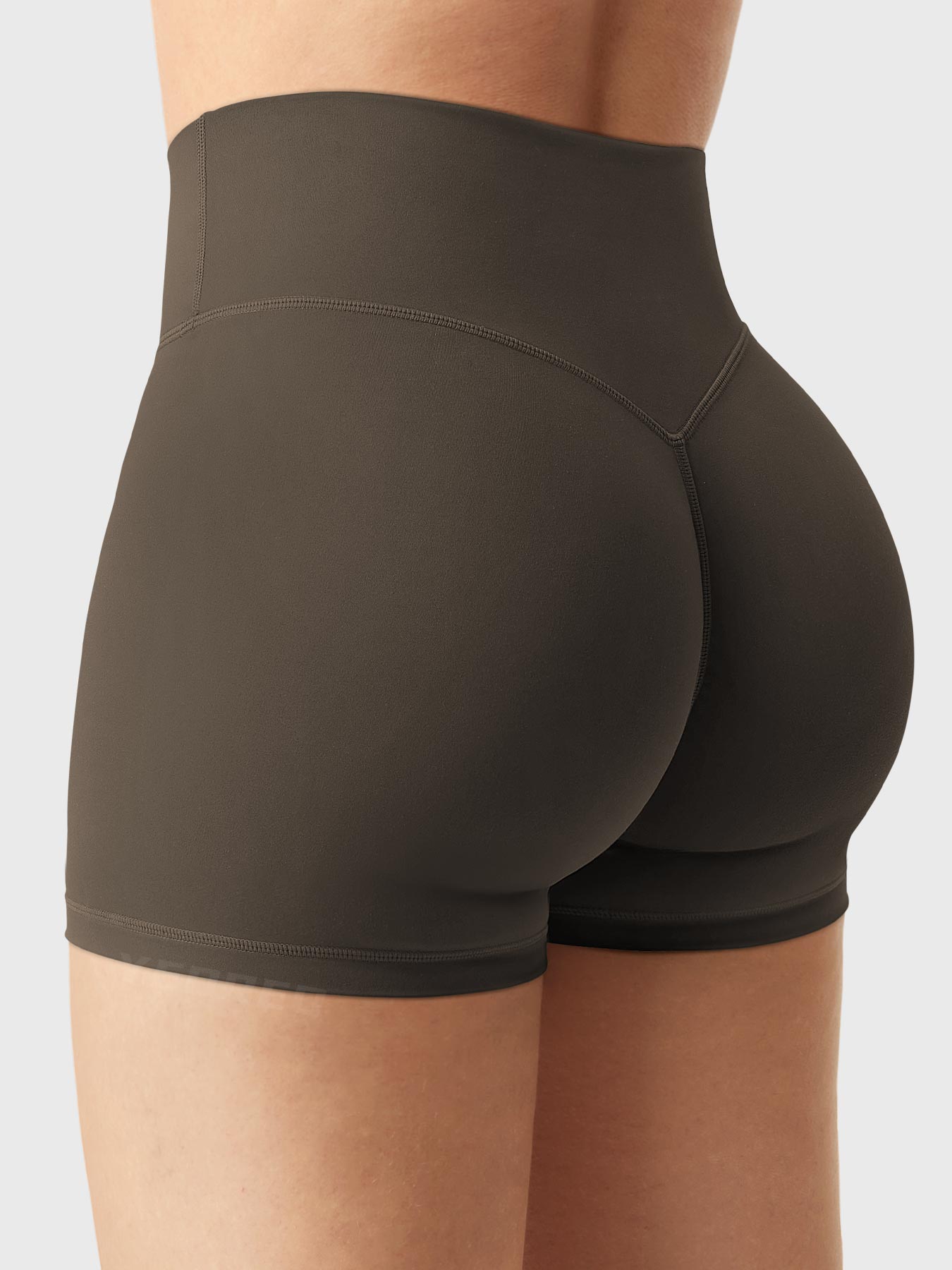 Side-back view of Yeoreo Elysina 2.5" Running Shorts in Deep Brown with model in different pose showing glute contour