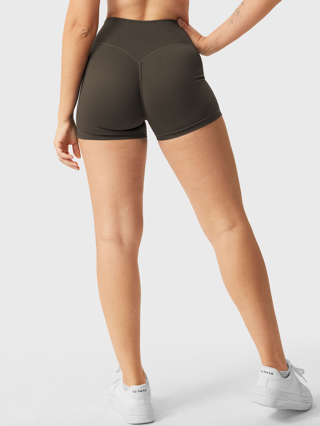 Full-length back view of Yeoreo Elysina 2.5" Running Shorts in Deep Brown from waist to shoes