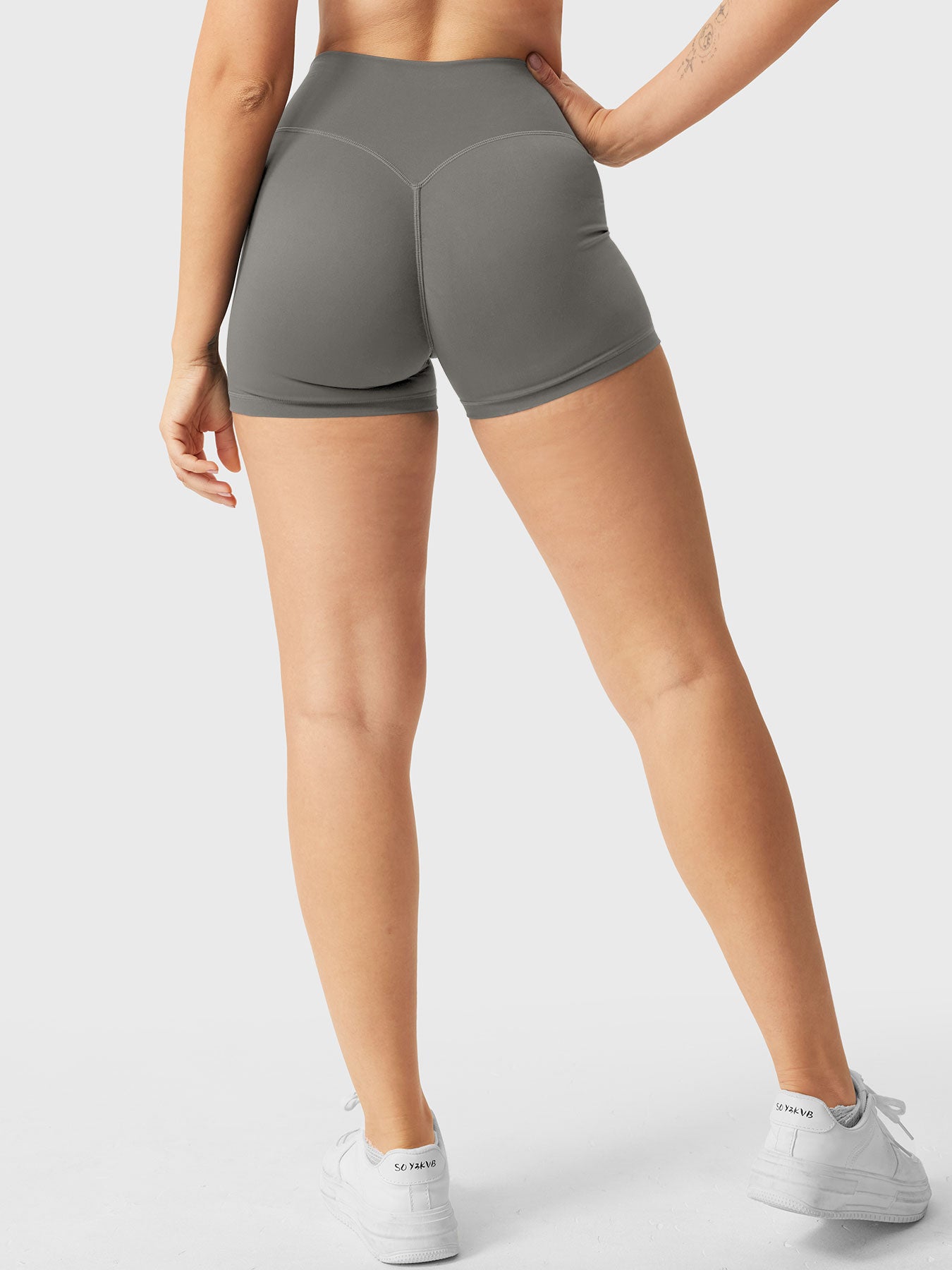 Full-length back view of Yeoreo Elysina 2.5" Running Shorts in Dark Grey from waist to shoes