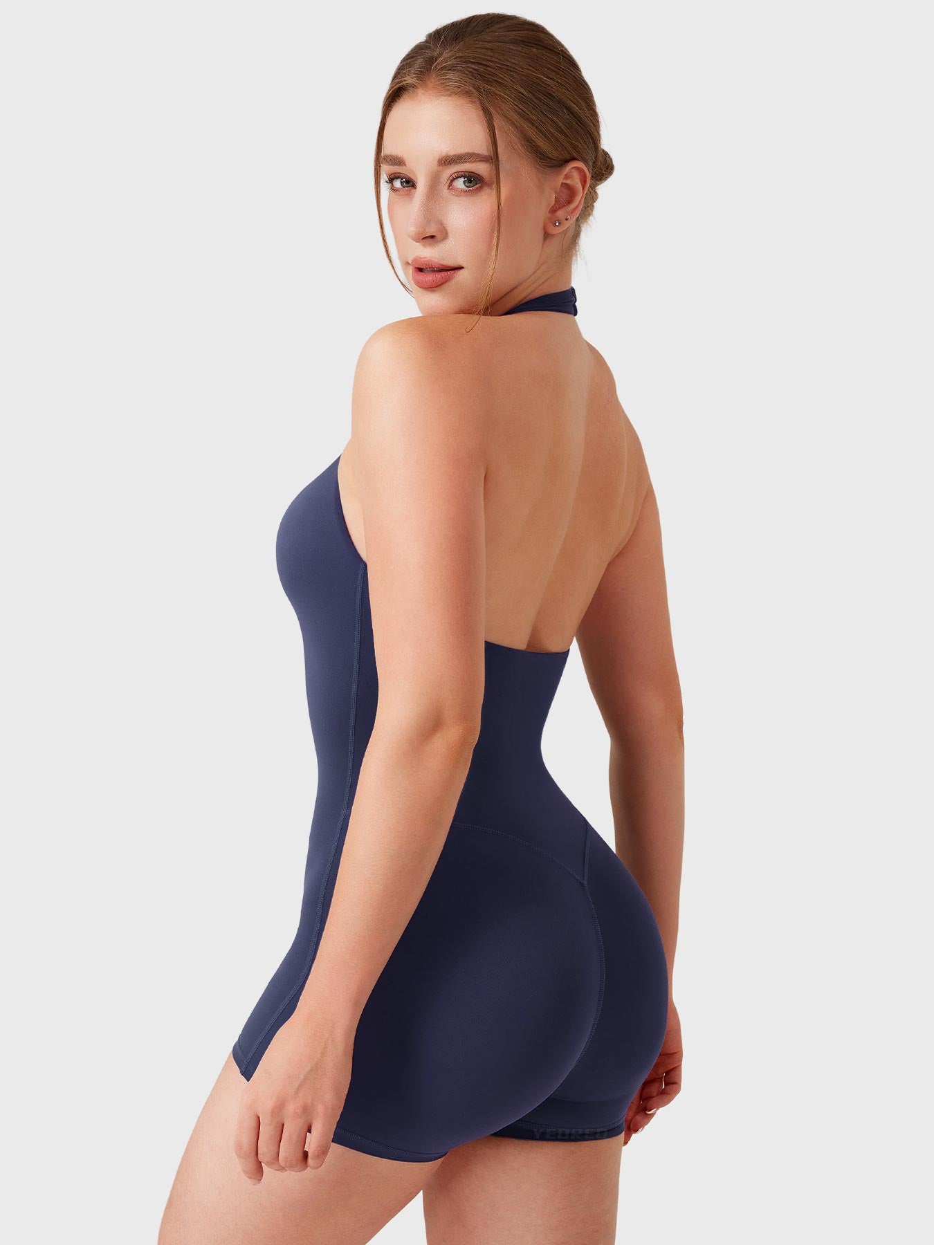 Dark Blue Yeoreo Daiane halter romper angled back view, subtle glute contour enhancing natural lift