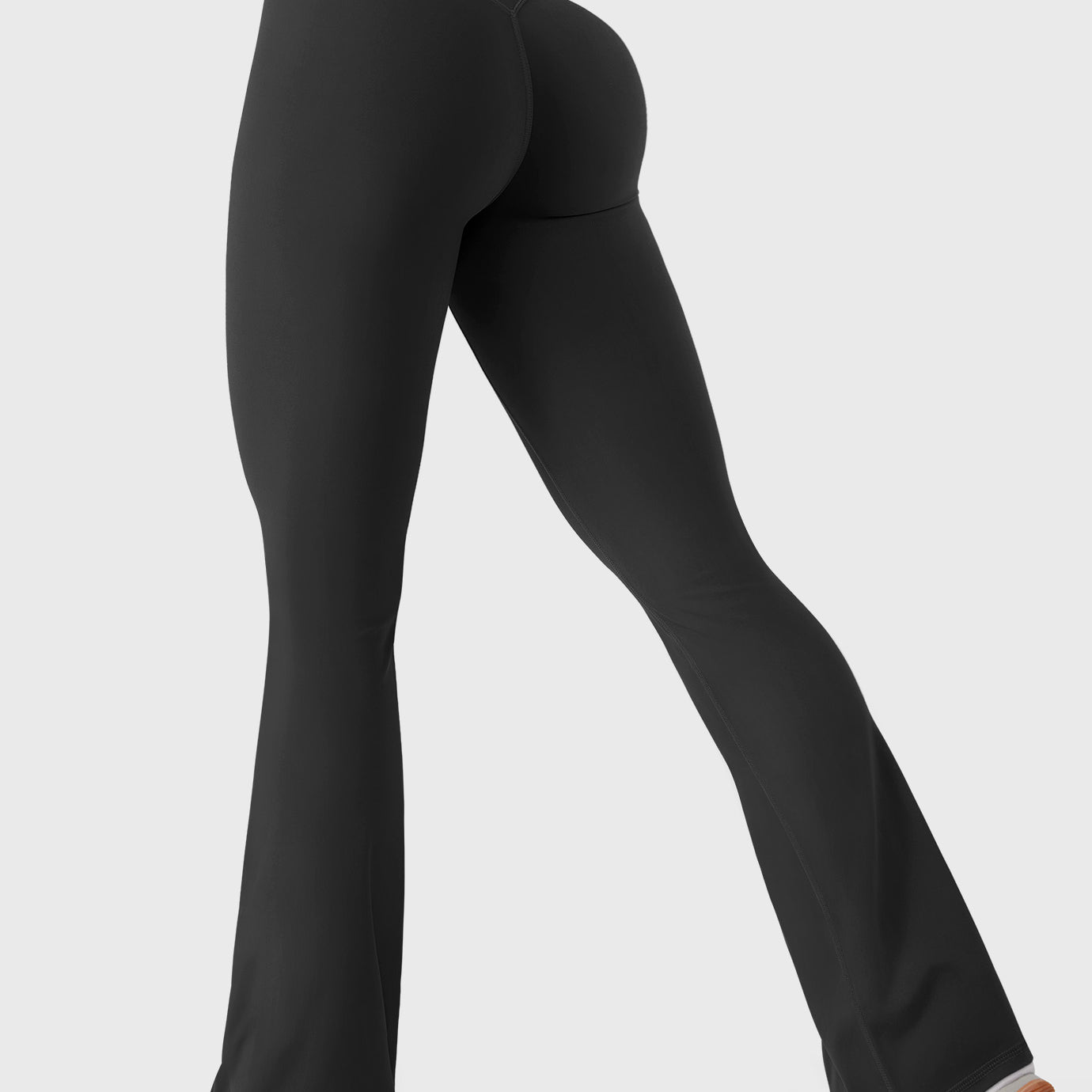 Black bootcut mini flare leggings with V-back and hidden scrunch, side-back walking pose
