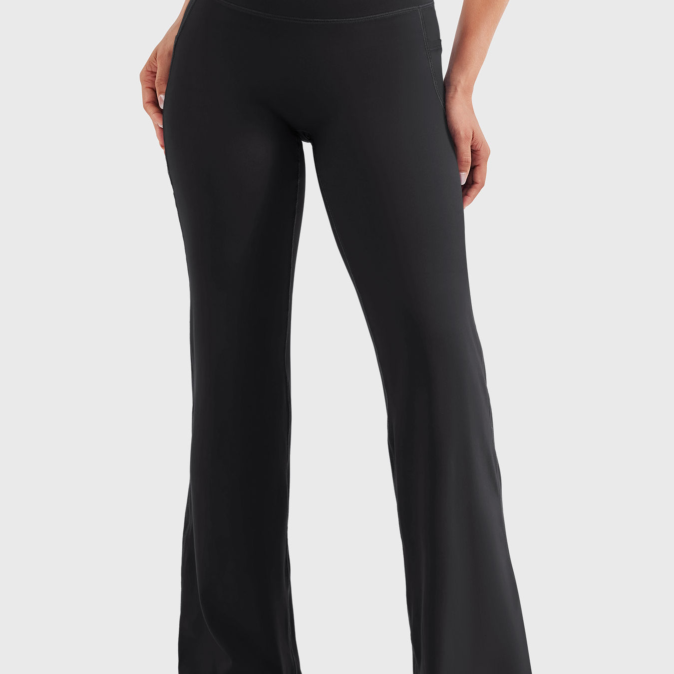 Front view—model wearing black high waisted straight leg leggings with no front seam, 29-inch inseam