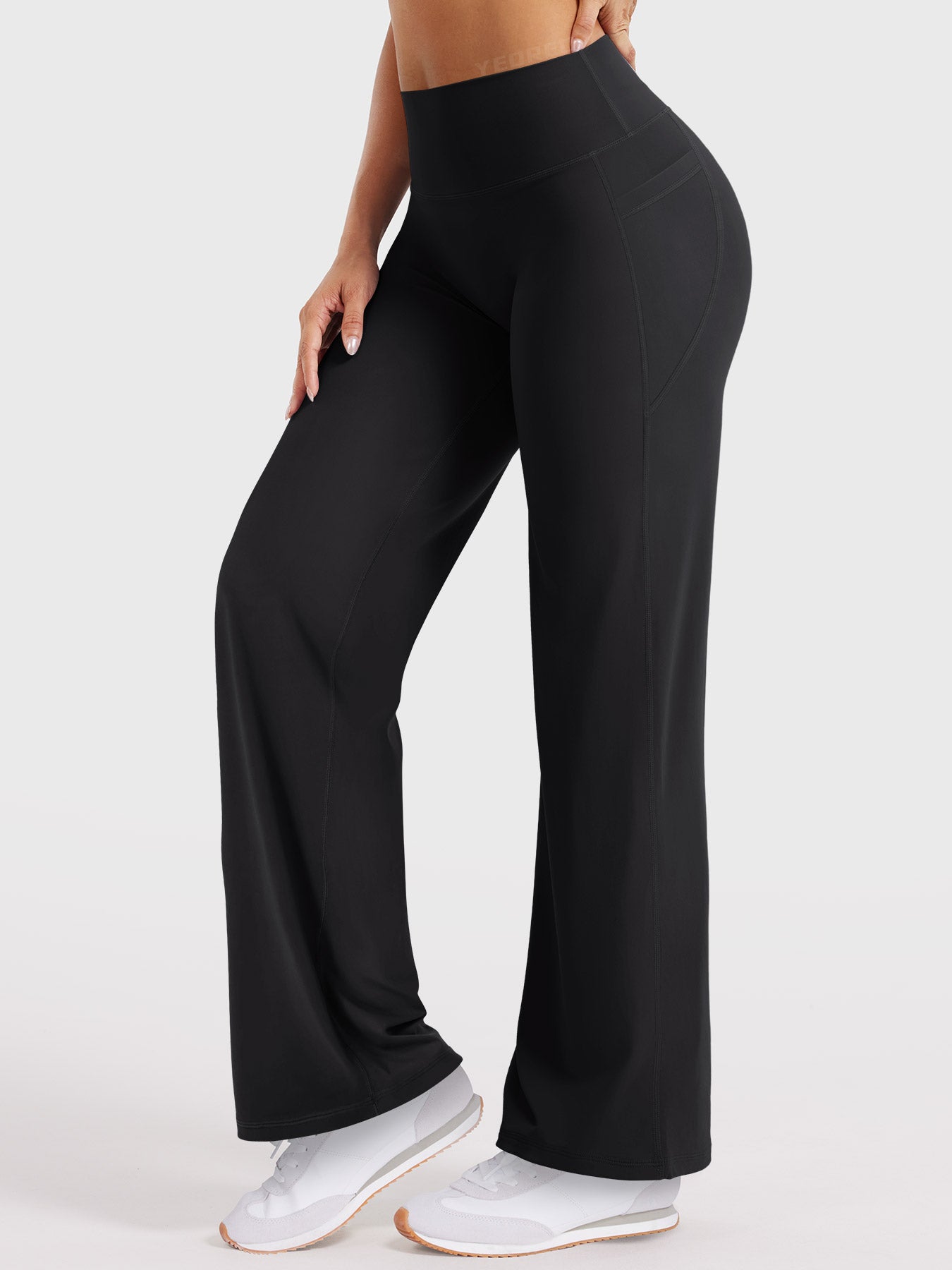 Side-front pose wearing black straight leg leggings with pockets, comfortable all-day wear