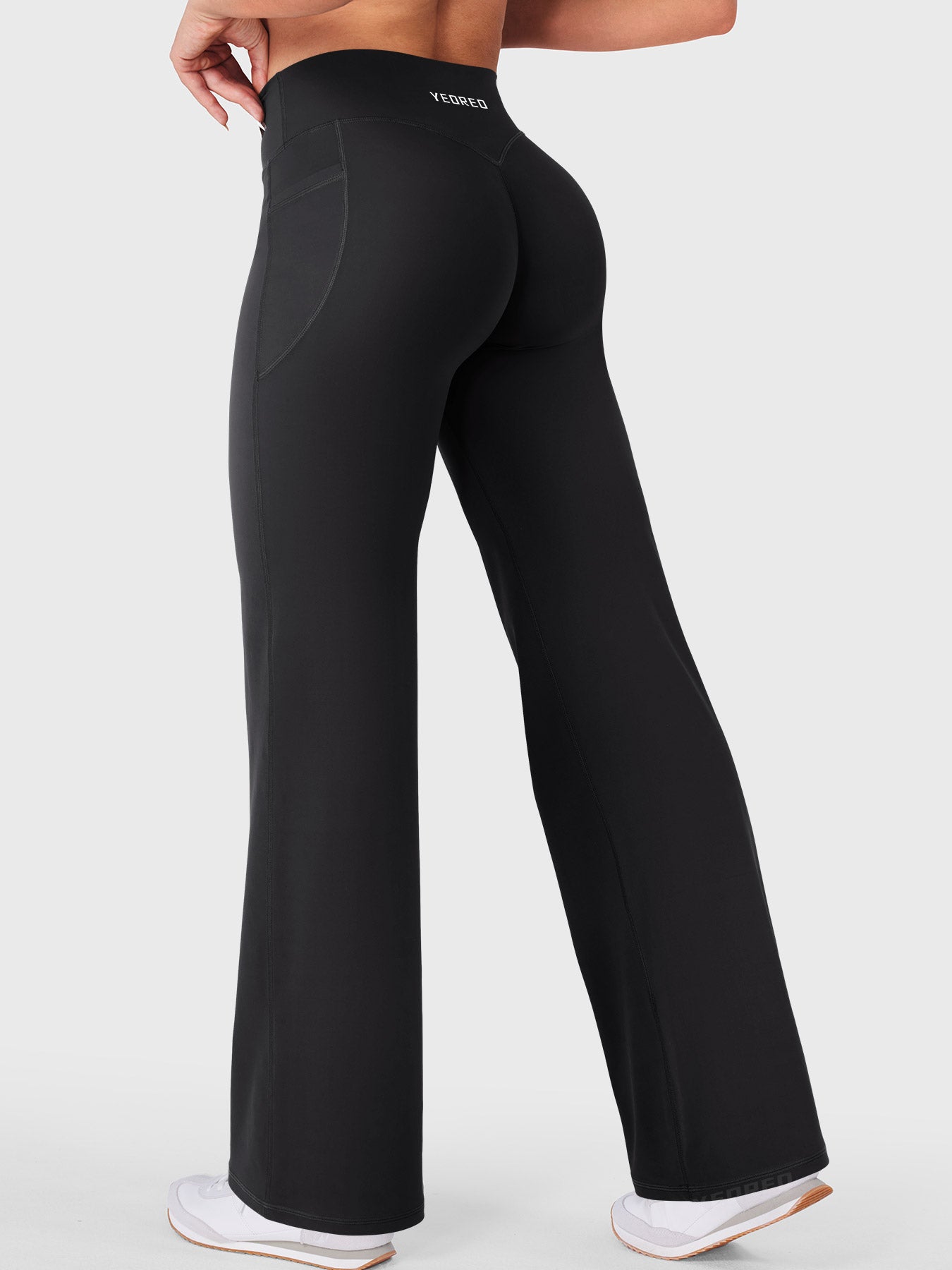 Black straight leg athleisure leggings worn while walking, effortless gym to street style