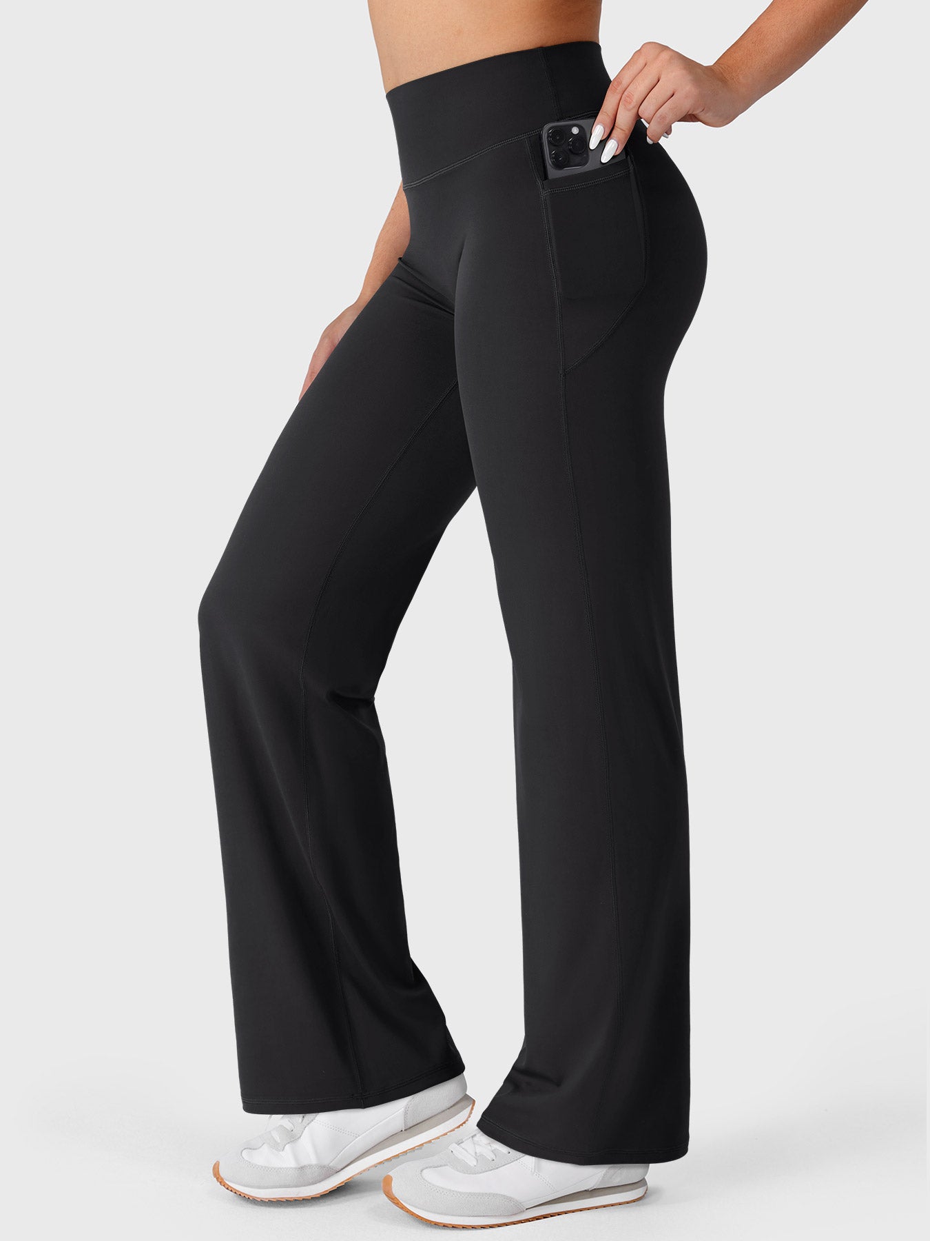 Black straight leg leggings side view with phone placed inside pocket