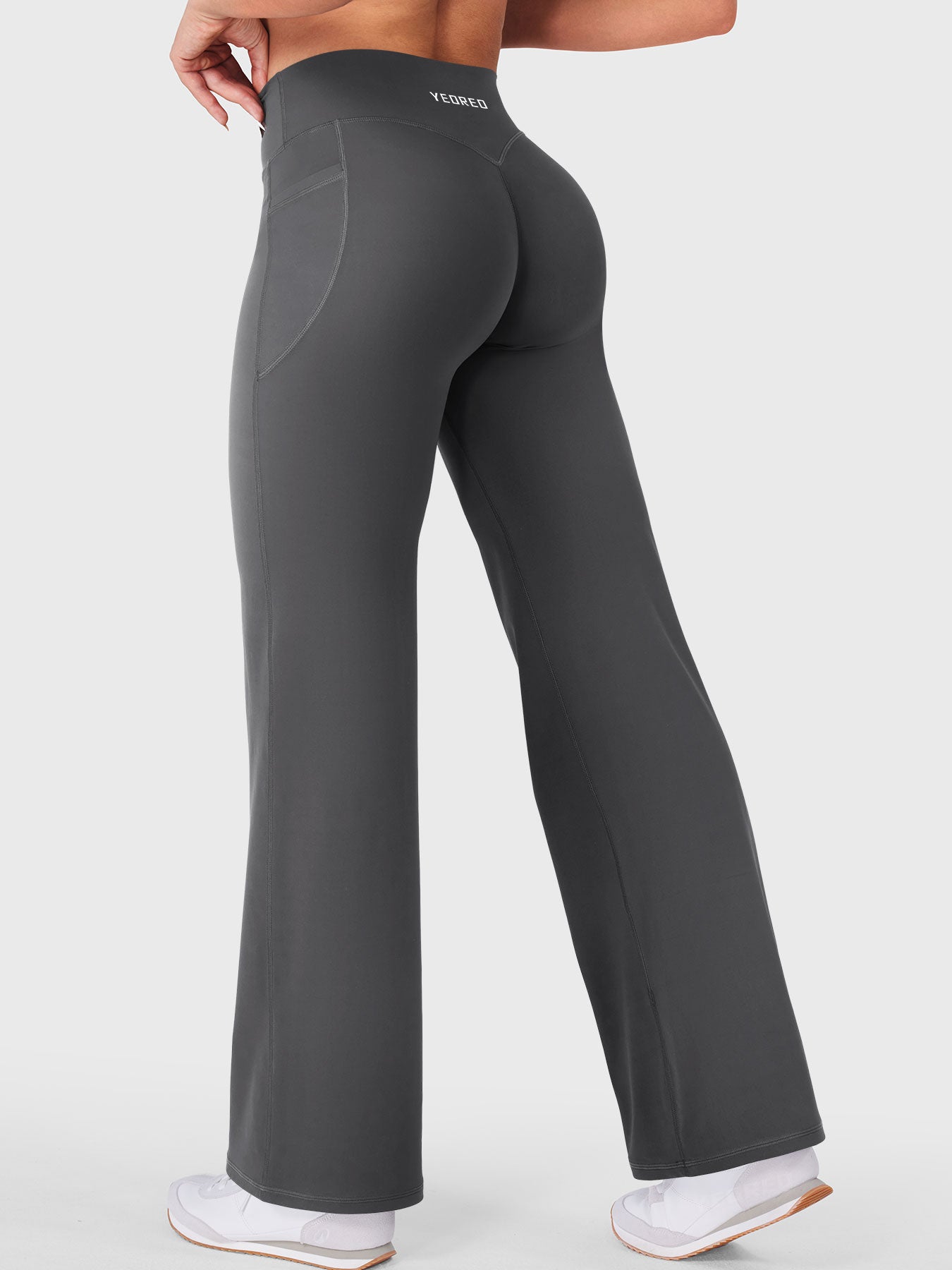 Walking side-back view in dark grey straight leg leggings with pockets, casual daily wear