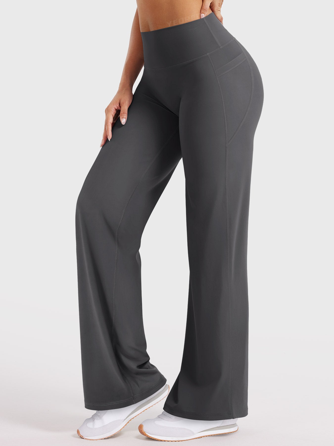 Dark grey buttery soft straight leg leggings in forward lunge pose, flexible everyday movement