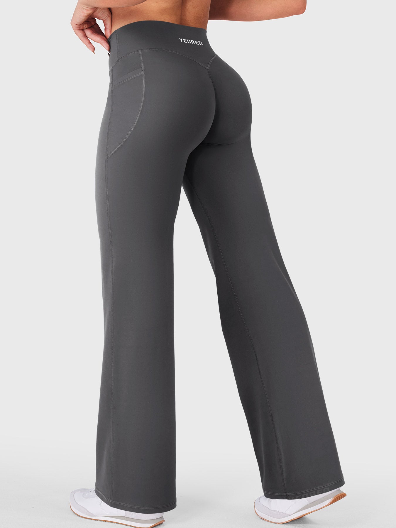 Dark grey athleisure straight leg leggings worn while walking, gym to street comfort look