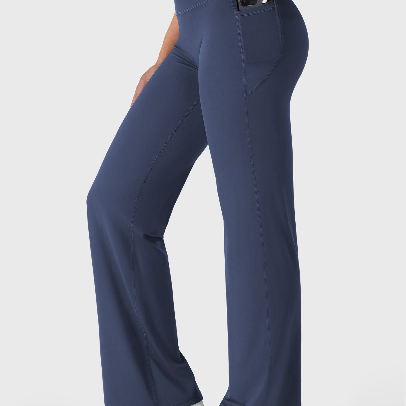 Navy straight leg leggings side view showing phone placed inside deep side pocket