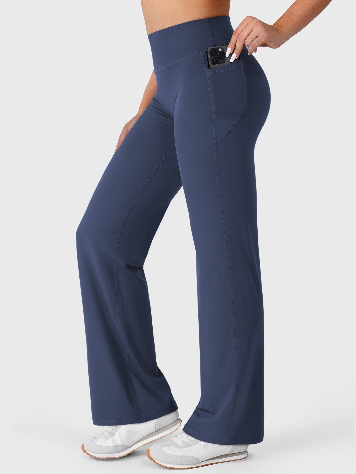 Navy straight leg leggings side view showing phone placed inside deep side pocket