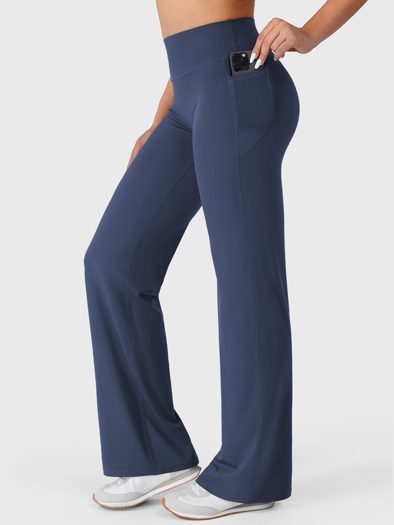 Navy straight leg leggings side view showing phone placed inside deep side pocket