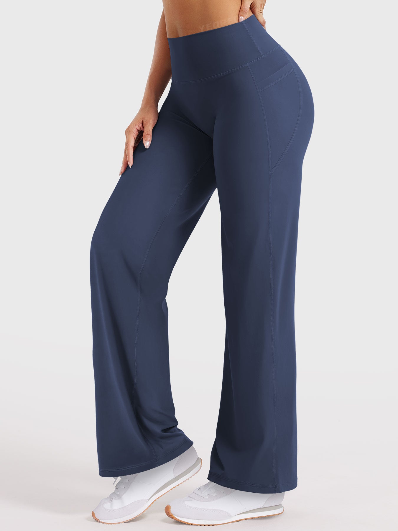 Side-front pose wearing navy straight leg leggings with pockets, high waisted fit, 29-inch inseam