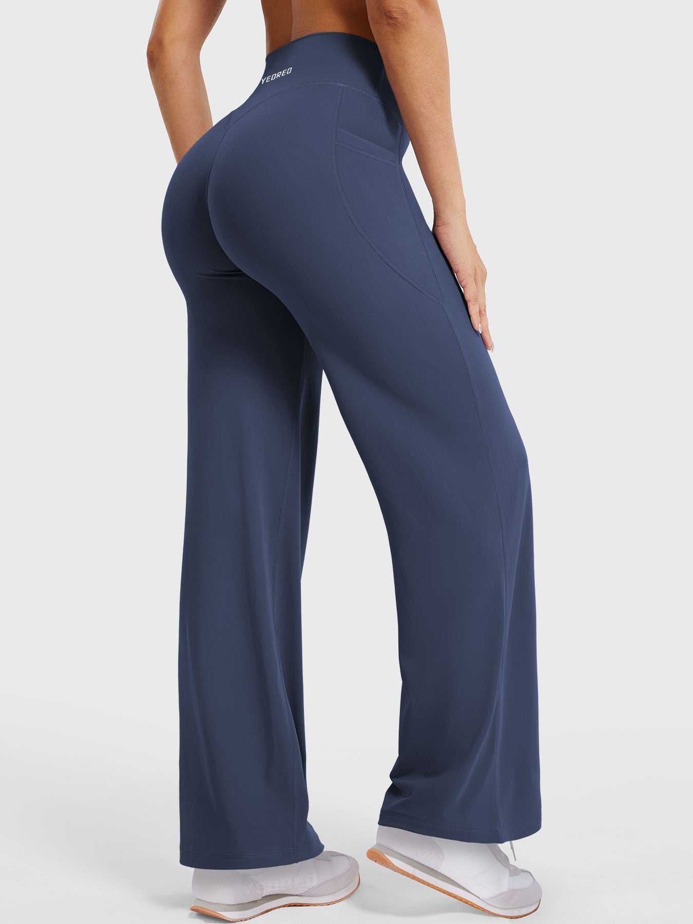 Side-back view showing navy straight leg leggings with flattering V-back shaping, 29-inch inseam