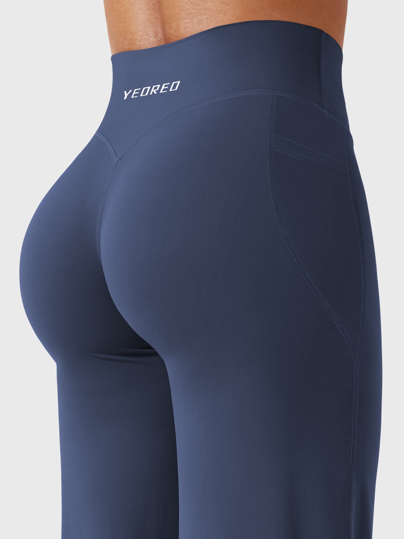 Back-angle close-up showing V-back detail and natural booty shaping in navy straight leg leggings