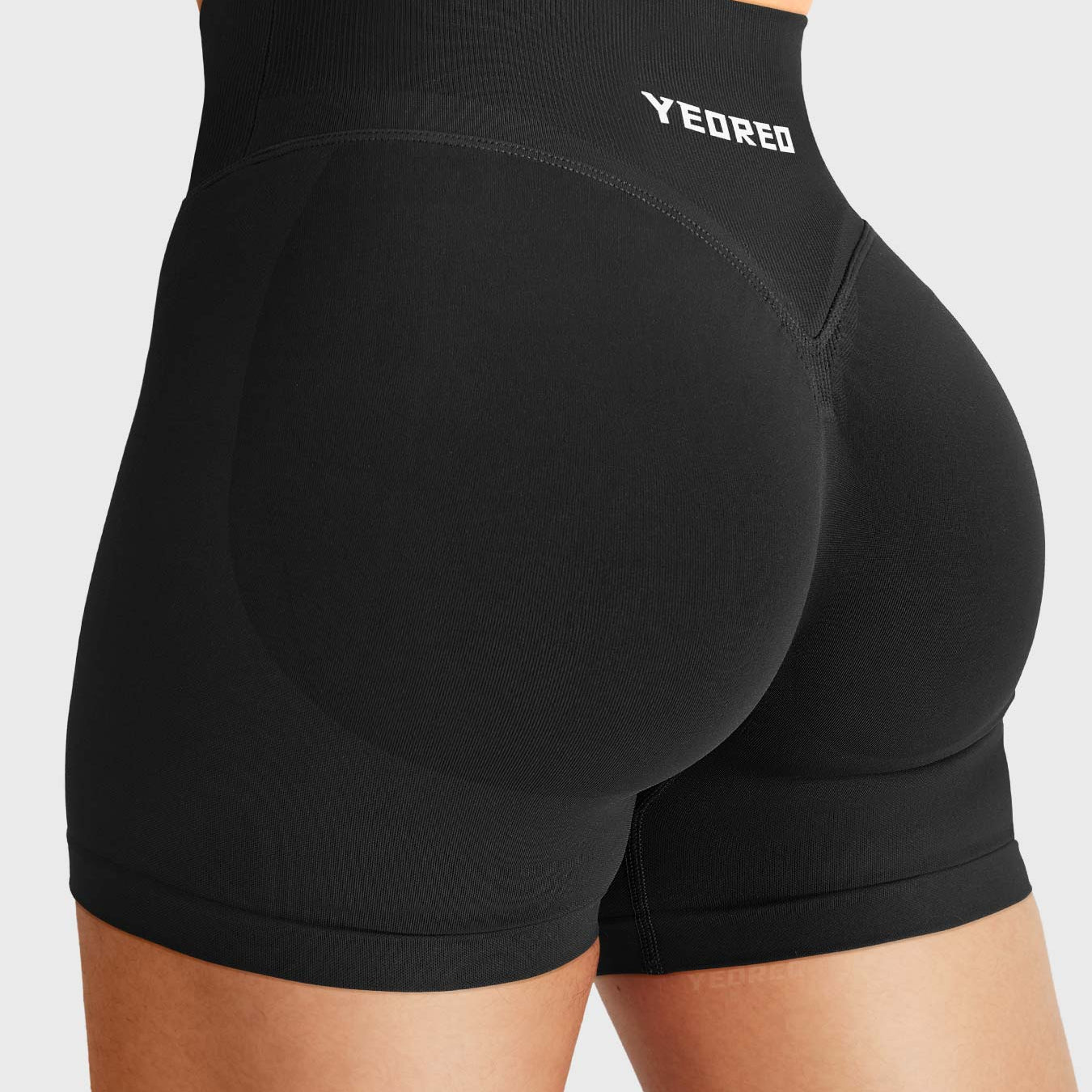 Black Baderiy 4.5" V-waistband seamless shorts angled back view, sculpted glute contour with natural lifting effect