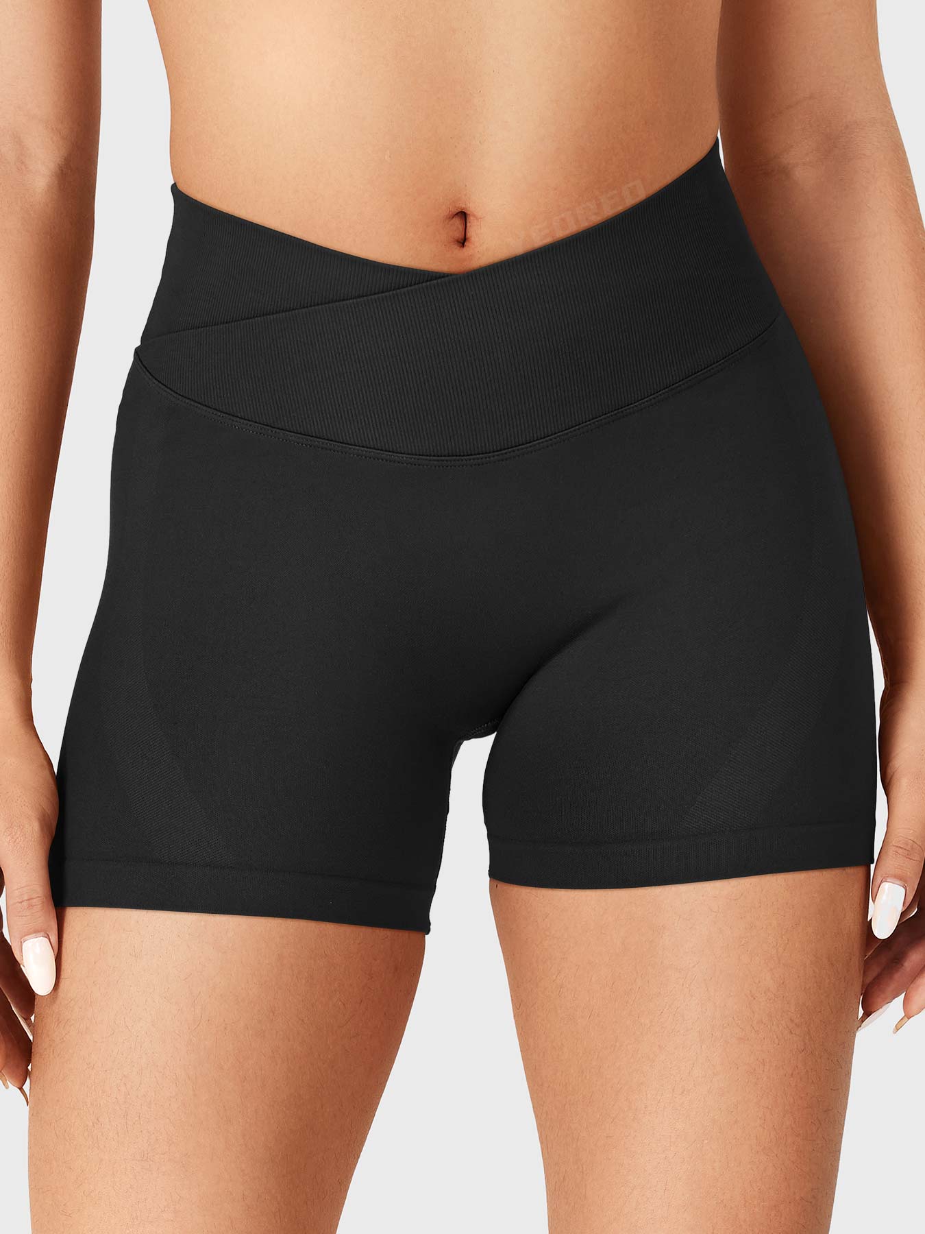 Black Baderiy 4.5" V-cross waistband seamless shorts front view, high-rise waist defining an hourglass silhouette without front seam